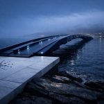 Sleek illuminated bridge extending into the night from a Cardano symbol platform, representing Midnight’s privacy layer aiming to expand the network’s reach